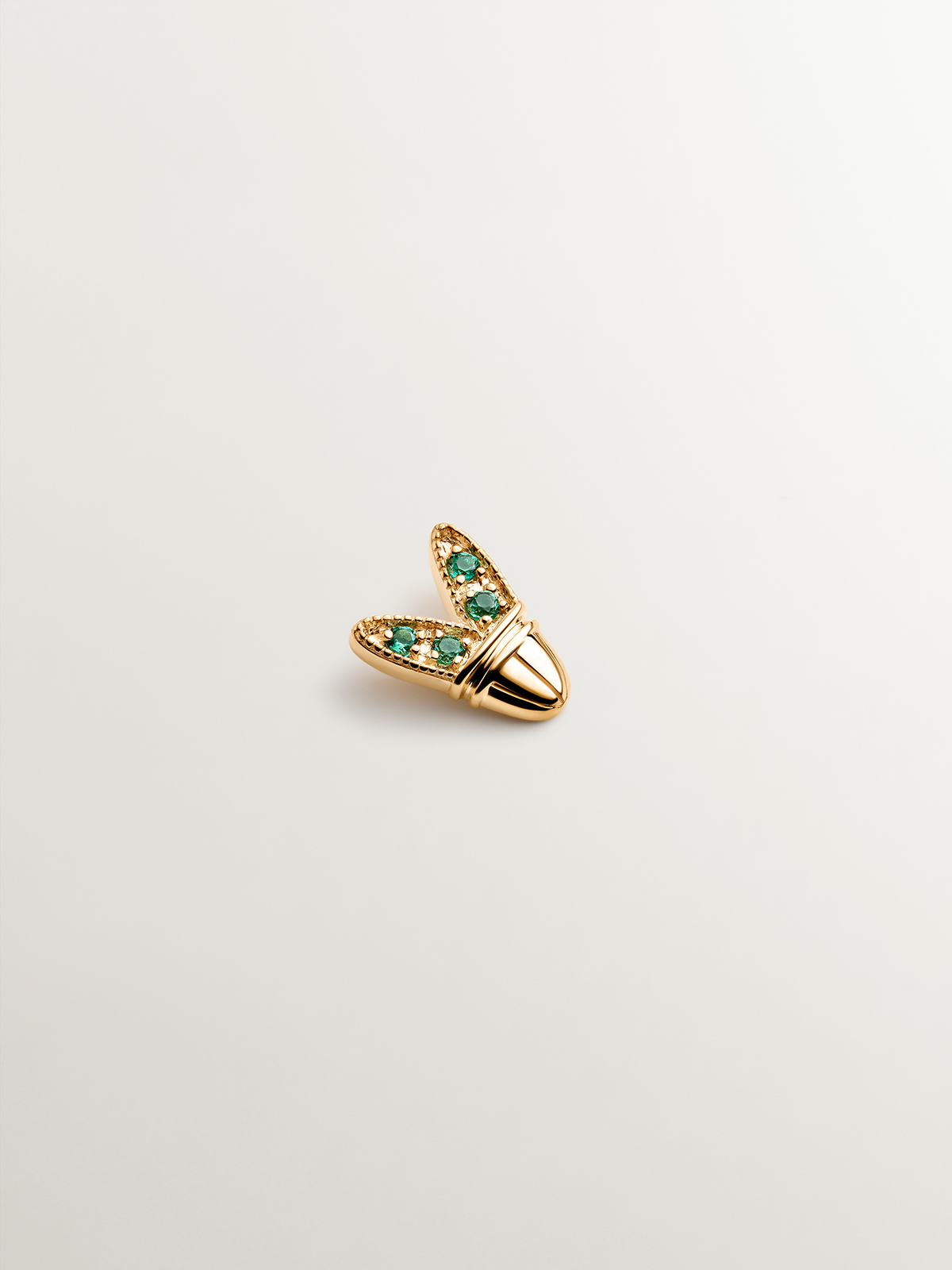 18K yellow gold piercing with emeralds and wing shape